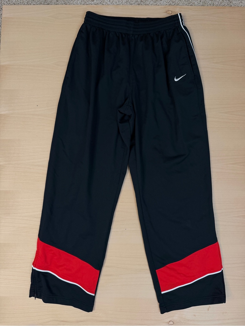 vintage black Nike basketball track pants featuring red XL